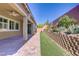 Inviting backyard patio with brick pavers, artificial turf, and landscaped retaining wall at 3155 Dalmazia Ave, Henderson, NV 89044