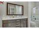 Charming bathroom with double vanity, framed mirror, and shower-tub combination at 3155 Dalmazia Ave, Henderson, NV 89044