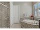 Bathroom featuring a granite shower and tub, creating a spa-like atmosphere at 3155 Dalmazia Ave, Henderson, NV 89044