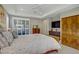 Bright bedroom with large windows, a plush bed, and stylish wooden furniture at 3155 Dalmazia Ave, Henderson, NV 89044