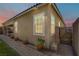 Rear exterior of home with landscaped walkway, side gate, and desert landscape at 3155 Dalmazia Ave, Henderson, NV 89044