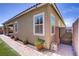 Rear exterior of home with landscaped walkway, side gate, and desert landscape at 3155 Dalmazia Ave, Henderson, NV 89044
