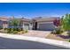 Beautiful home featuring a paver driveway, desert landscaping, and a two-car garage at 3155 Dalmazia Ave, Henderson, NV 89044