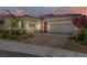 Beautiful home featuring a paver driveway, desert landscaping, and a two-car garage at 3155 Dalmazia Ave, Henderson, NV 89044