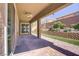 Beautiful covered patio with brick pavers, ceiling fan, and lush landscaping at 3155 Dalmazia Ave, Henderson, NV 89044