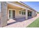 Expansive covered patio featuring brick pavers and manicured landscaping at 3155 Dalmazia Ave, Henderson, NV 89044