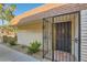 Front entrance featuring brick accents, secure gate, and well-maintained landscaping at 3310 Heritage Pl, Las Vegas, NV 89121