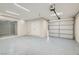 Spacious two-car garage with an automatic door, epoxy flooring, and a large storage closet at 3310 Heritage Pl, Las Vegas, NV 89121