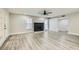 Spacious living room with fireplace, bright lighting, and modern gray wood floors at 3310 Heritage Pl, Las Vegas, NV 89121