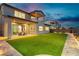 Covered patio and outdoor seating overlooking the backyard with low-maintenance turf at 350 Gandara St, Las Vegas, NV 89138