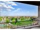 Expansive view from balcony overlooking lush greenery, neighborhood park, and distant cityscape at 350 Gandara St, Las Vegas, NV 89138