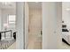 Hallway view of the bathroom, with a shower and a bedroom at either end at 350 Gandara St, Las Vegas, NV 89138