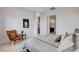 Bright bedroom with an ensuite bathroom featuring a leather chair, a modern rug and neutral decor at 350 Gandara St, Las Vegas, NV 89138