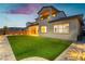 Back exterior of house with low-maintenance turf, tile patio, and balcony at 350 Gandara St, Las Vegas, NV 89138