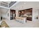 A view of the open kitchen with a large island and seating from an overhead loft at 350 Gandara St, Las Vegas, NV 89138