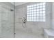 Bathroom featuring a glass shower with marble and a glass block window for natural light at 4227 Pacifico Ln, Las Vegas, NV 89135