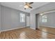 This bedroom features wood floors, a ceiling fan, a door and a mirrored wardrobe at 4227 Pacifico Ln, Las Vegas, NV 89135