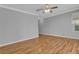 Bedroom featuring wood floors, a ceiling fan, crown molding, and a large window at 4227 Pacifico Ln, Las Vegas, NV 89135