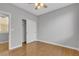 This bedroom features wood floors, a ceiling fan, a door and a closet at 4227 Pacifico Ln, Las Vegas, NV 89135
