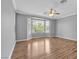 Spacious bedroom featuring wood floors, a ceiling fan, and a bay window with natural light at 4227 Pacifico Ln, Las Vegas, NV 89135