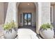 Covered entryway featuring double glass doors and decorative planters at 4227 Pacifico Ln, Las Vegas, NV 89135