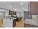 Spacious kitchen featuring dark wood cabinets, granite countertops, and a central island at 4227 Pacifico Ln, Las Vegas, NV 89135