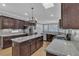 Modern kitchen featuring a center island, stainless steel appliances, and dark wood cabinetry at 4227 Pacifico Ln, Las Vegas, NV 89135