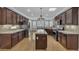 Open kitchen with granite countertops, stainless appliances, wood floors, and dark wood cabinets at 4227 Pacifico Ln, Las Vegas, NV 89135