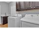 Modern laundry room featuring a sink, cabinets, washer, and dryer at 4227 Pacifico Ln, Las Vegas, NV 89135