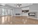 Spacious living room with hardwood floors, fireplace, and open layout to kitchen at 4227 Pacifico Ln, Las Vegas, NV 89135