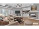 Staged living room with fireplace, hardwood floors, and view of kitchen at 4227 Pacifico Ln, Las Vegas, NV 89135