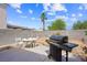 Backyard area featuring a patio, grill, and ample room for activities at 4336 Desert Dancer Way, Las Vegas, NV 89147