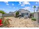 Backyard featuring desert landscaping, a patio set, and flowering oleander bushes at 4336 Desert Dancer Way, Las Vegas, NV 89147