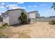 Desert backyard featuring privacy wall, compact patio area, and exterior of home at 4336 Desert Dancer Way, Las Vegas, NV 89147