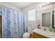 Bathroom featuring a bright window, a seashell-themed shower curtain, and plenty of amenities at 4336 Desert Dancer Way, Las Vegas, NV 89147