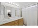 Bright bathroom featuring a double sink vanity and shower with a white curtain at 4336 Desert Dancer Way, Las Vegas, NV 89147