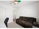 Bedroom area with a comfy couch, closet and bright, colorful ceiling fan at 4336 Desert Dancer Way, Las Vegas, NV 89147