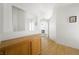 Bright hallway featuring hardwood floors, fresh white paint, and sightlines into the living room at 4336 Desert Dancer Way, Las Vegas, NV 89147