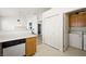 Functional kitchen layout with breakfast bar, adjacent laundry area, and ample storage space at 4336 Desert Dancer Way, Las Vegas, NV 89147