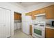 Practical kitchen with gas range, laundry access, and convenient storage solutions at 4336 Desert Dancer Way, Las Vegas, NV 89147