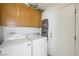 Functional laundry room with overhead cabinets and side-by-side washer and dryer at 4336 Desert Dancer Way, Las Vegas, NV 89147