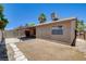 Backyard view showcasing the home's exterior, patio covering, and mature landscaping at 4533 Diamond Head Dr, Las Vegas, NV 89110