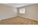 Cozy bedroom with neutral carpet, base trim and natural light from the window at 4533 Diamond Head Dr, Las Vegas, NV 89110
