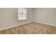 This bedroom offers neutral walls, tan carpet, and a window for natural light at 4533 Diamond Head Dr, Las Vegas, NV 89110