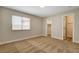 Bedroom featuring carpet flooring, base trim, a window, and two entryways at 4533 Diamond Head Dr, Las Vegas, NV 89110