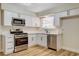 Updated kitchen featuring stainless steel appliances, white cabinets, and a modern design at 4533 Diamond Head Dr, Las Vegas, NV 89110