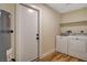 Bright laundry area with modern washer, dryer, and shelving for storage at 4533 Diamond Head Dr, Las Vegas, NV 89110