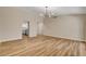 Bright, open-concept living room with wood floors and stylish light fixture at 4533 Diamond Head Dr, Las Vegas, NV 89110