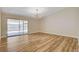 Bright living room with wood floors, sliding glass doors, and a modern chandelier at 4533 Diamond Head Dr, Las Vegas, NV 89110