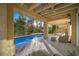 Inviting covered patio with ceiling fan, stylish seating, and a sparkling pool, perfect for outdoor relaxation and entertaining at 5125 Turnberry Ln, Las Vegas, NV 89113